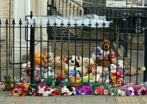 Tributes outside the flat of Fiona Anderson, who took her own life and that of her three children