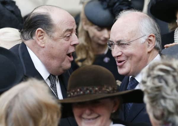 Sir Nicholas Soames talks to Michael Howard following a service of Thanksgiving for the Life and Work of his mother Lady Soames, at Westminster Abbey
