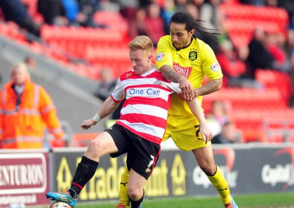 Doncaster's Mark Duffy holds off Town's Sean Scannell