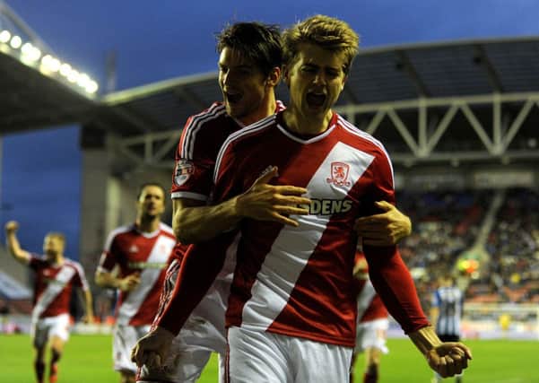 Middlesbrough's Patrick Bamford celebrates with George Friend (left) after scoring his side's first goal during the Sky Bet Championship match at the DW Stadium, Wigan.