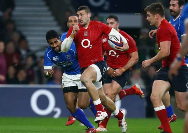England's Jonny May (centre) on his way to scoring a try against Samoa.