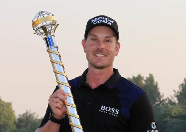 Henrik Stenson from Sweden holds the trophy of the DP World Golf Championship as he poses for a picture after the final round of DP World Golf Championship, in Dubai, United Arab Emirates, Sunday, Nov. 23, 2014. Stenson has successfully defended his DP World Tour Championship title at the European Tour's season-ending event. (AP Photo)