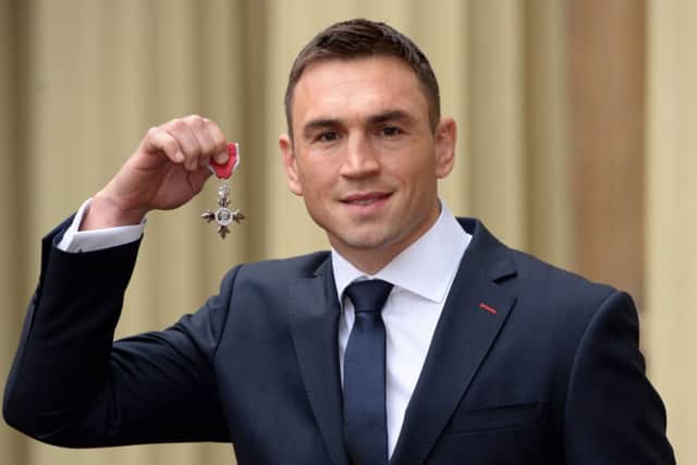 Leeds Rhinos' captain Kevin Sinfield holds his mbe after the Investiture ceremony at Buckingham Palace. Below: Actor Damian Lewis receives his OBE.