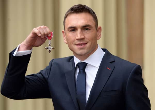 Leeds Rhinos' captain Kevin Sinfield holds his mbe after the Investiture ceremony at Buckingham Palace. Below: Actor Damian Lewis receives his OBE.