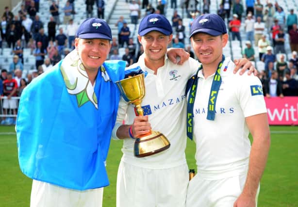 NEW ERA: Joe Root, pictured celebrating with the County Championship trophy alongside team-mates Gary Ballance and Rich Pyrah, has agreed a new two-year contract with Yorkshire.