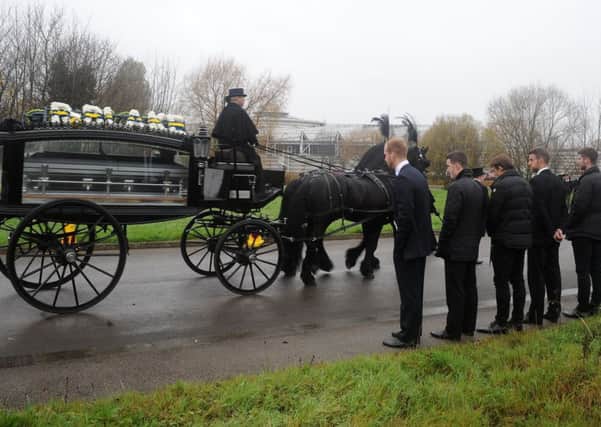 Leeds United players including Michael Tonge and Stephen Warnock pay their respect as the coffin of Blake Cairns, brother to Leeds United goalkeeper Alex Cairns, goes past.