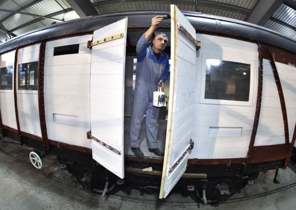 Ian Mathews puts the finishing touches to the restoration of the Southern Railway Baggage van which carried Winston Churchill's coffin at the National Railway Museum's site at Shildon