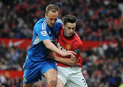 Tom Lawrence, right, seen playing for Manchester United and challenging Hull City's David Meyler (Picture: Martin Rickett/PA Wire).
