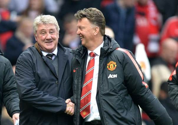 Hull City manager Steve Bruce enjoys a joke with Manchester United manager Louis van Gaal before a match which would give the Tigers' boss nothing to smile about (Picture Martin Rickett/PA Wire).