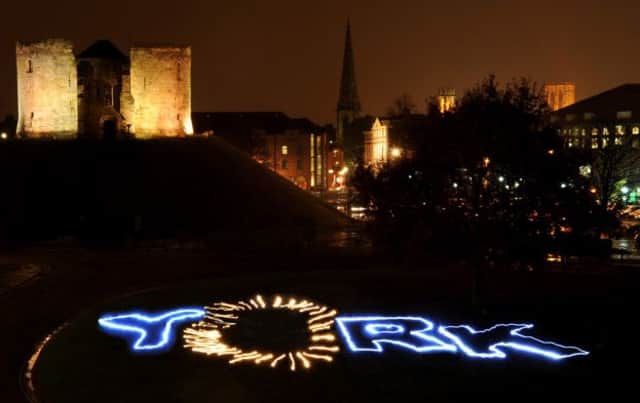 York is spelled out in lights against the backdrop of Clifford's Tower.