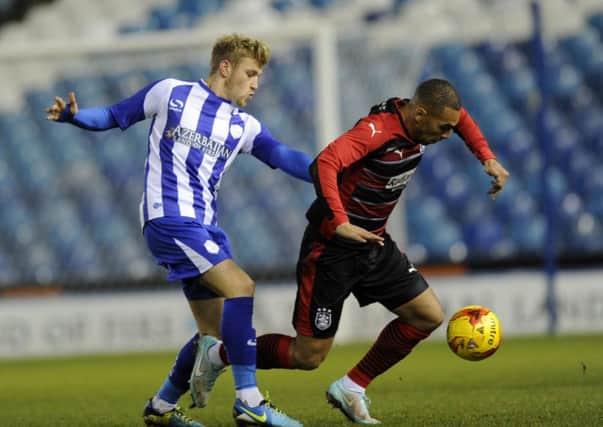 James Vaughan, right, tussles with Sheffield Wednesday's Ryan Croasdale in Huddersfield Town's Professional Development League Two clash with the Owls
