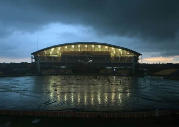 STORM WARNING: Clouds hover over Mahinda Rajapaksa Stadium as ground crew cover the field ahead of the third one-day international.. Pictures: AP.