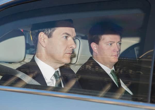 Chancellor George Osborne and Treasury Chief Secretary Danny Alexander leave the Treasury in London for the House of Commons