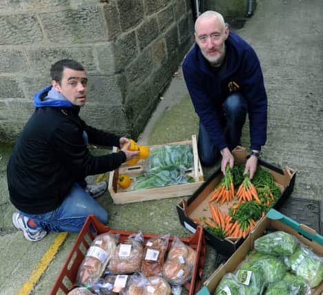 Volunteers Stephen  Cattanach (left) and  Derek Allan sorting  some of the food given by Fodder to the  Harrogate Homeless Project at Wesley Chapel in Harrogate