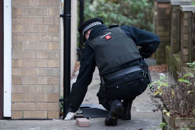 Police search the gardens of the vicarage in Sunnyside Close, Freckleton, Lancashire