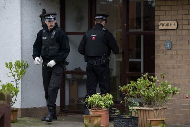 Police search the gardens of the vicarage in Sunnyside Close, Freckleton, Lancashire