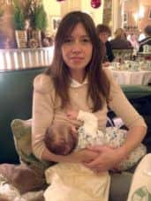 Louise Burns  breastfeeding her child  before she was asked to cover  up with  a white shroud in Claridges, London.