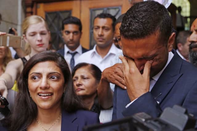 Ami Denborg, left,  and her brother Anish Hindocha, right, react after the court case that acquitted their sister's former husband Shrien Dwani from murdering her at the high court in Cape Town