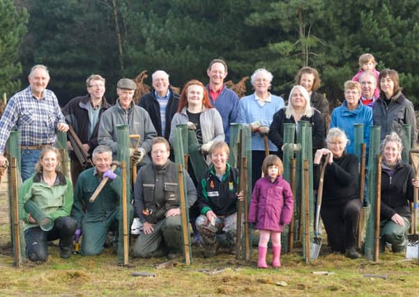 Volunteers help plant a hedge at the Three Hagges Jubilee Wood.  Pic: Mike Cowling.