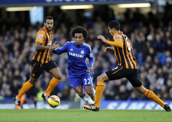 Chelsea's Willian (left) dives during a challenge by Hull City's Curtis Davis (right).
