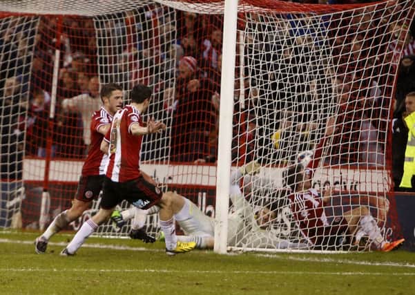 Southampton goalkeeper Fraser Forster is dismayed and Sheffield United delighted after Marc McNulty netted the goal which sees the Blades in the League Cup semi-finals (Picture: Martyn Harrison).