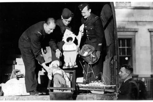 French Airmen deliver their handcrafted toys to York Mansion House, on Christmas Eve 1944.