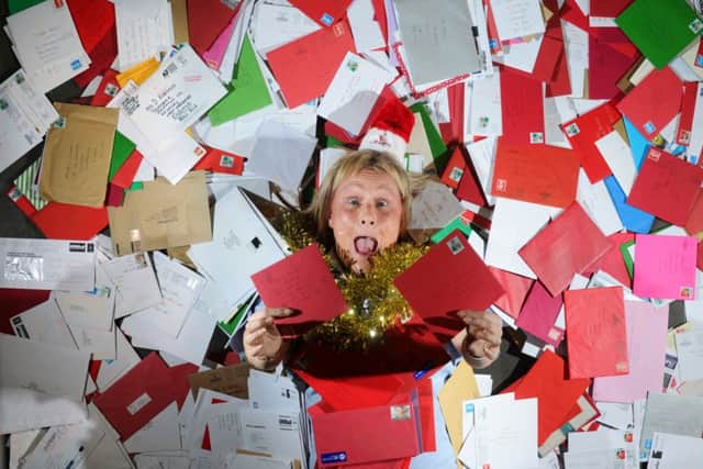 Lisa Jackson from Swillington, Leeds, among the Christmas letters at the Royal Mail sorting office. Pictures by Simon Hulme
