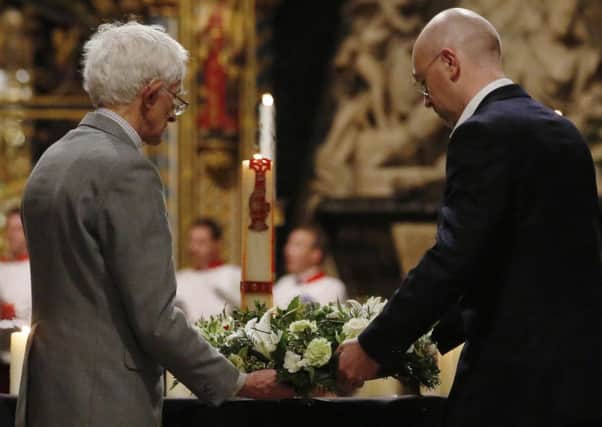 Jim (left) and William Swire lay a wreath for the victims of the Lockerbie bombing during a service of remembrance