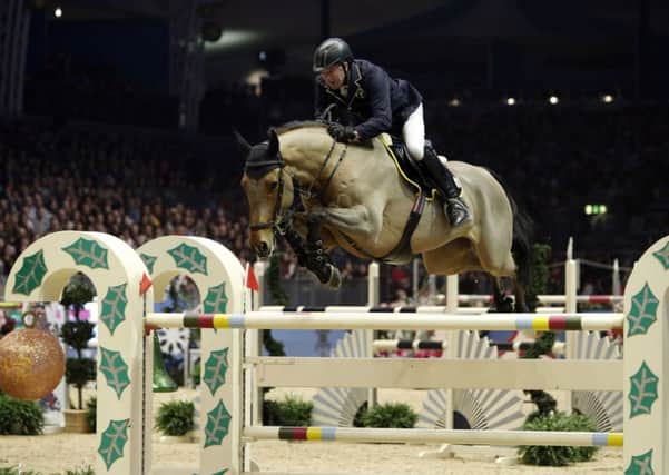 Yorkshire's John Whitaker, riding Lord of Arabia, competes in the Shelley Ashman International Ltd, E M Rogers (Transport) Ltd Christmas Tree Stakes at Olympia (Picture: Steve Parsons/PA Wire).