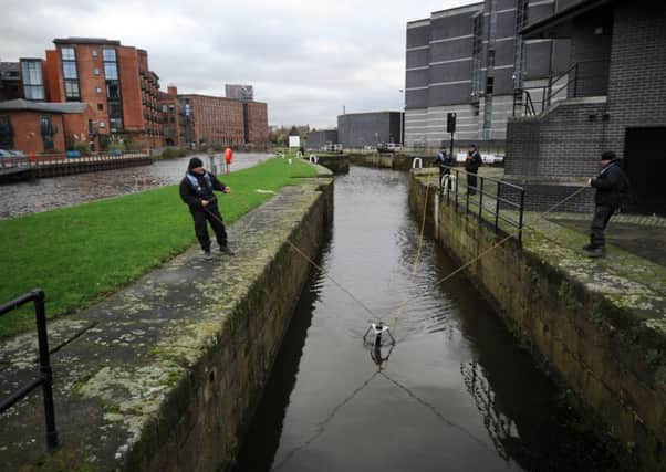 Police search the waterways by the Royal Armouries. PIC: Simon Hulme