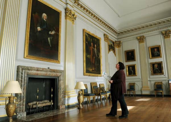 Joanne Parker from Beningbrough Hall looks at a portrait of the 4th Earl of Chesterfield , Philip Dorner Stanhope, by George Knaptin in 1745 in the Saloon, main picture; the Hall is exhibiting a number of paintings from the National Portrait Gallery collection.