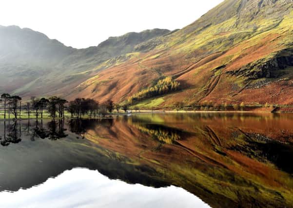 Autumn reflections on Buttermere in the Lake District in Cumbria. PIC: PA