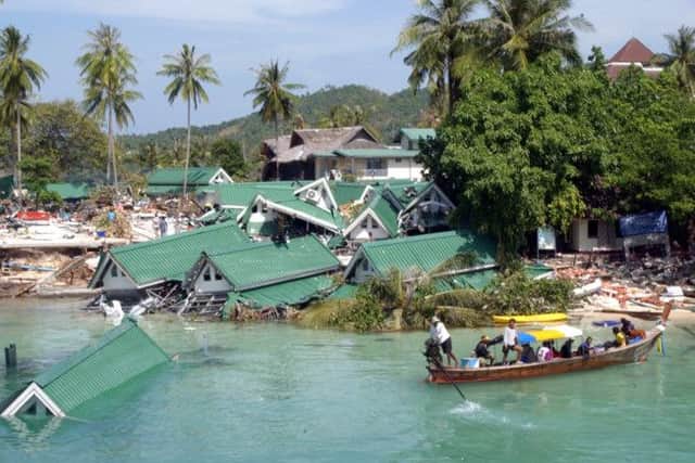 A boat passes by a damaged hotel, at Ton Sai Bay on Phi Phi Island, in Thailand
AP Photo/Suzanne Plunkett, File