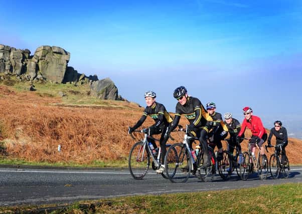Members of Ilkley Cycling Club pass the Cow and Calf.