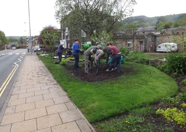 Volunteers helping 'Incredible Edible Todmorden' with planting projects in the town.