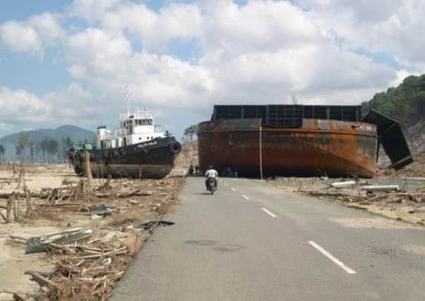 A coal barge on a coastal road in Aceh, Indonesia, following the devastating tsunami. (Kim Tan).