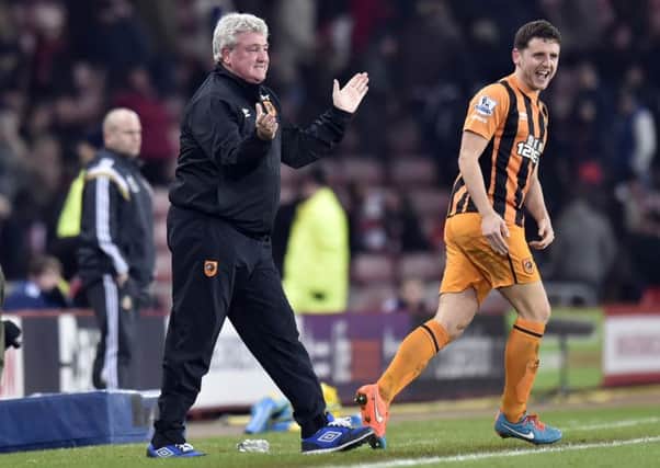 Hull City manager Steve bruce celebrates after his side score their third goal.