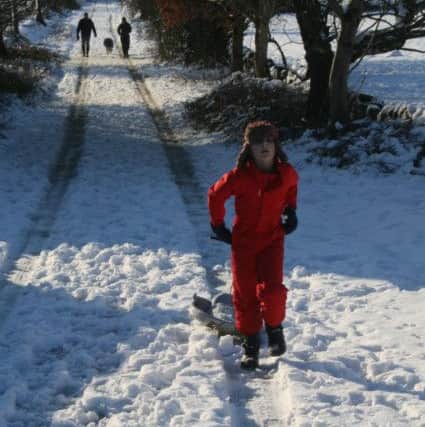 Eddie, aged 10, pulls his sledge up a hill in Loxley, Sheffield