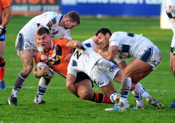 Tigers' Mike McMeeken is tackled by Rovers' Liam Walmsley, Alex Forster and Paul Sykes.