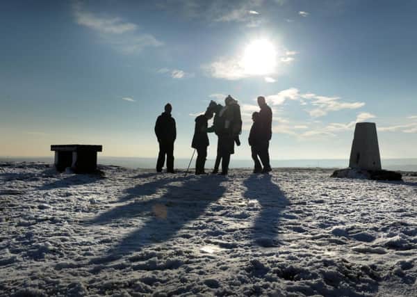 Walkers stop to admire the view on the top of Baildon Moor.