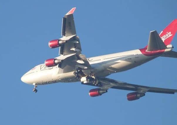 Screen grab image taken from the Twitter feed of @atcfrase of a Virgin Atlantic passenger plane which is trying to land back at Gatwick airport.