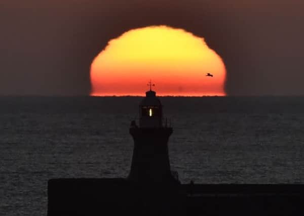The sun rises for the  last time in 2014 over Tynemouth on the North East Coast. PIC: PA