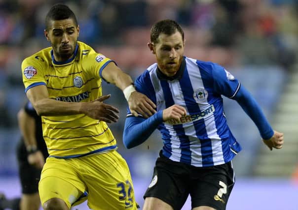 Sheffield Wednesday's Lewis McGugan, left, battles with Wigan Atheltic's Chris McCann at the DW Stadium on Tuesday night. Picture: Martin Rickett/PA.