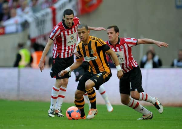 WEMBLEY DATE: Michael Doyle battles with Liam Rosenior in last season's FA Cup semi-final. Picture: Martyn Harrison.
