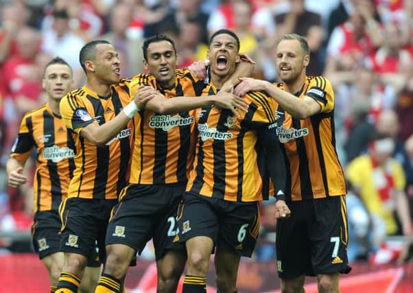 Hull City's Curtis Davies, (6) celebrates after scoring the second goal of the FA Cup final with his team-mates