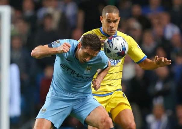 Manchester City's Frank Lampard wins the ball from Sheffield Wednesday's Giles Coke during the Capital One Cup Third Round match at the Etihad Stadium, Manchester.