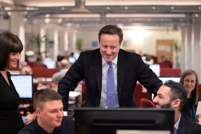 David Cameron meets staff at Covea Insurance at Dean Clough Mills in Halifax, as the PM kick-started the general election year by promoting the Tories' first campaign poster.