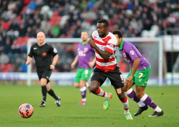 STALEMATE: Doncaster Rovers' 

Theo Robinson gets past Bristol City's Korey Smith in a 1-1 draw at the Keepmoat Stadium. Picture: Steve Uttley.