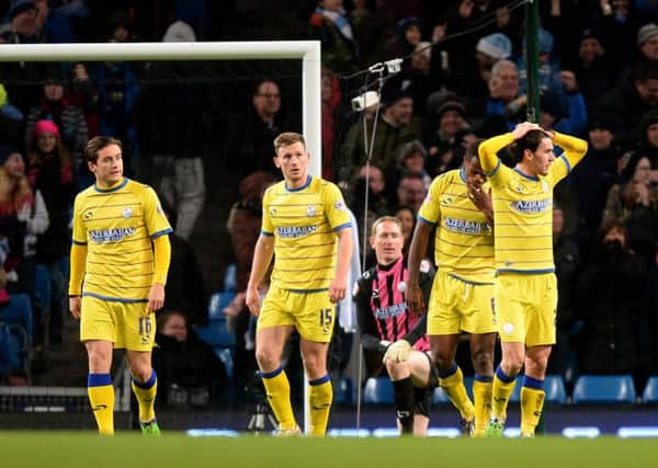 AGONY: Sheffield Wednesday's players show their dejection after Manchester City's James Milner scores his second goa. Picture: PA.