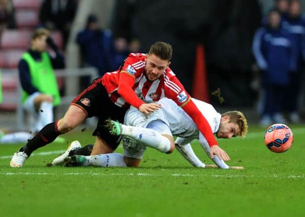 DOWN AND OUT: Leeds 
United's Gaetano Berardi, right, battles with Sunderland's Connor Wickham. 
Picture: Jonathan Gawthorpe.